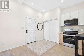 Toronto (Banbury-Don Mills) apartment for rent - A kitchen area with a clock on the wall and a door to the right.