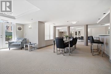 Toronto (The Beaches) condo for rent - A spacious living room with a grey sofa and black chairs.