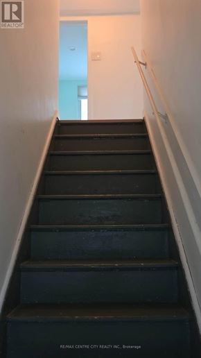 London North (North G) apartment for rent - A staircase with a black railing and steps.