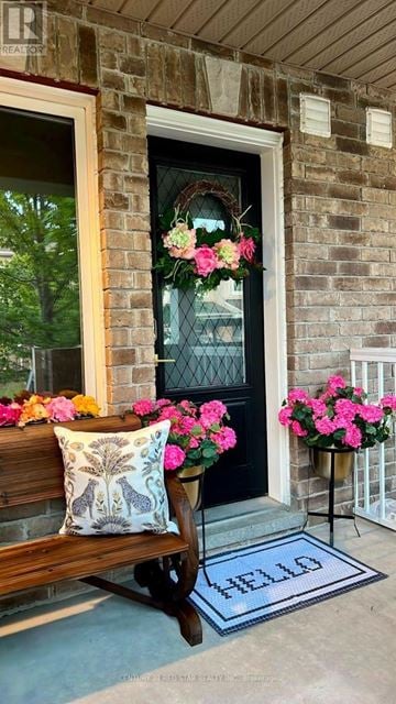 Barrie (Innis-Shore) townhouse for rent - A house entrance with a pillow and a mat on the floor.