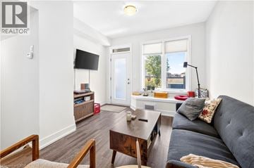 Waterdown townhouse for rent - A living room with a grey couch and a wooden coffee table.