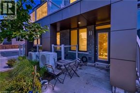 Waterdown townhouse for rent - A modern house with a patio and outdoor furniture.