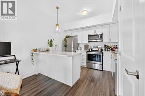 Waterdown townhouse for rent - A modern kitchen with white cabinets and stainless steel appliances.