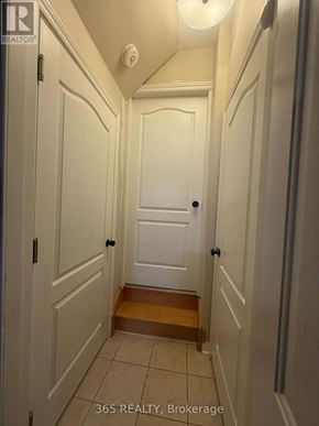 Milton (Cl Clarke) apartment for rent - A hallway with white doors and a wooden step.