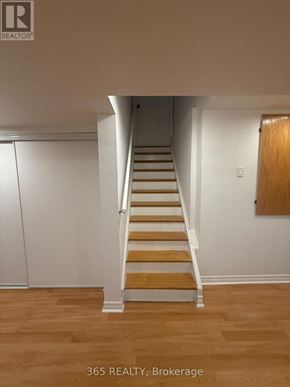 Milton (Cl Clarke) apartment for rent - A staircase with wooden steps and white railings.
