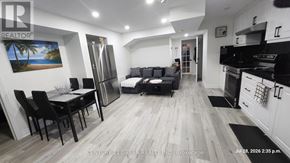 Milton (Fo Ford) apartment for rent - A well-lit, modern kitchen and living room with a dining table and chairs.