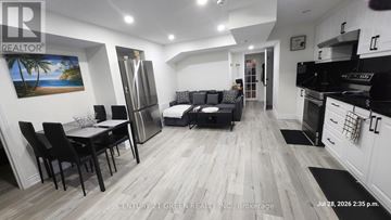 Milton (Fo Ford) apartment for rent - A well-lit, modern kitchen and living room with a dining table and chairs.