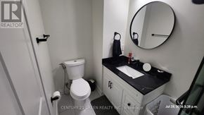 Milton (Fo Ford) apartment for rent - A bathroom with a toilet, sink, and mirror.