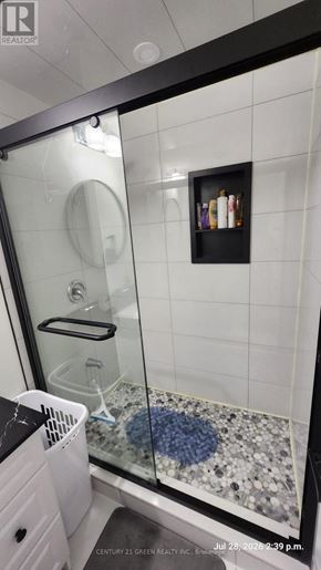 Milton (Fo Ford) apartment for rent - A bathroom with a glass shower door and a white trash can.