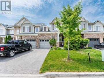 Milton (Ha Harrison) townhouse for rent - A black truck is parked in front of a house with a sign that says REALTOR.