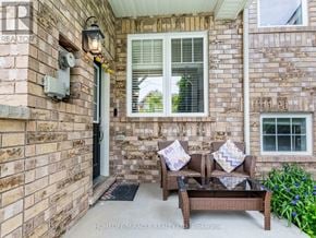 Milton (Ha Harrison) townhouse for rent - A patio with a couch and a table is shown.