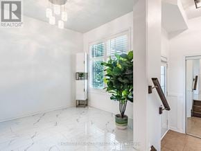 Milton (Ha Harrison) townhouse for rent - A white interior space with a plant and a cabinet.