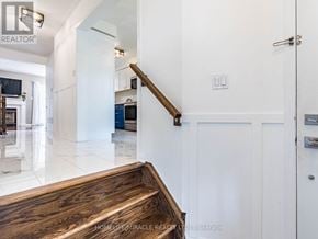 Milton (Ha Harrison) townhouse for rent - A white hallway with a wooden staircase and a white door.