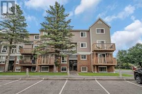 Ottawa townhouse for rent - A large apartment complex with a parking lot in front.