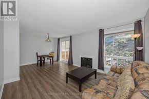 Ottawa townhouse for rent - A living room with a fireplace and a couch.
