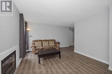 Ottawa townhouse for rent - A living room with a couch and a fireplace.