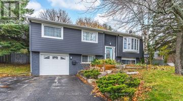 Barrie (Painswick North) apartment for rent - A two-story house with a garage is surrounded by trees and has a well-maintained front yard.