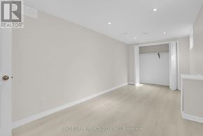 Barrie (Allandale Heights) apartment for rent - A spacious room with a door on the left and a window on the right.