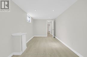 Barrie (Allandale Heights) apartment for rent - A white hallway with a window and a door at the end.