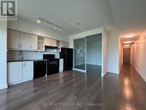 Toronto (Thorncliffe Park) condo for rent - A kitchen with black appliances and white cabinets.