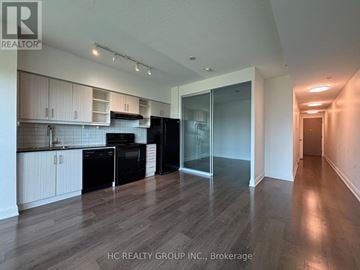 Toronto (Thorncliffe Park) condo for rent - A kitchen with black appliances and white cabinets.