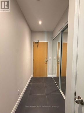 Toronto (Willowdale West) condo for rent - A hallway with a wooden door and a glass door.