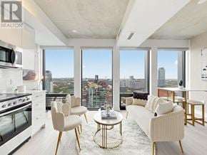 Toronto (Moss Park) condo for rent - A modern living room with a view of the city skyline.