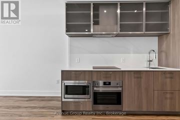 Toronto (Willowdale East) condo for rent - A modern kitchen with wooden cabinets and stainless steel appliances.