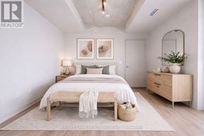 Toronto (Moss Park) condo for rent - A bedroom with a bed, nightstand, and a mirror.