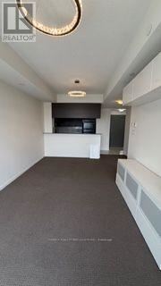 Brampton (Bram West) condo for rent - A long, narrow hallway with a light on the ceiling and a white wall on the right side.