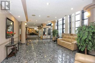 Mississauga (Hurontario) condo for rent - A spacious living room with a marble floor and furnished with a sofa, armchair, and a coffee table.