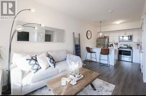 Hamilton (Waterdown) townhouse for rent - A modern living room with a white couch and a wooden coffee table.