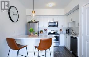 Hamilton (Waterdown) townhouse for rent - A modern kitchen with a white countertop and brown chairs.