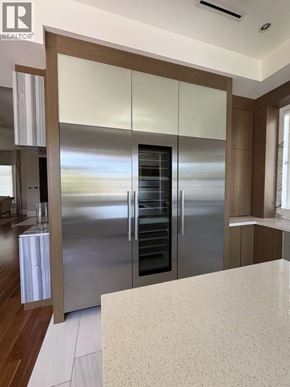 Vancouver apartment for rent - A modern kitchen with a stainless steel refrigerator and wooden cabinets.