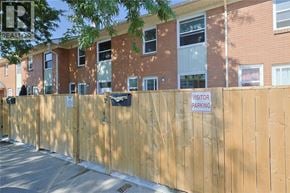 Sarnia townhouse for rent - A wooden fence with a sign that says "VISITOR PARKING" on it.
