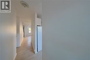Sarnia townhouse for rent - A hallway with a REALTOR sign on the wall.