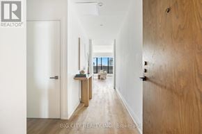 Toronto (Thorncliffe Park) condo for rent - A hallway with a white door on the left and a wooden door on the right.