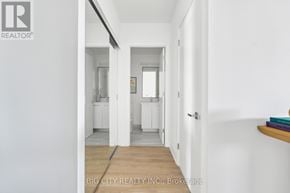 Toronto (Thorncliffe Park) condo for rent - A hallway with a white wall and a wooden floor.
