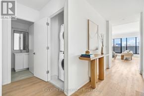 Toronto (Thorncliffe Park) condo for rent - A realtor photo of a modern apartment with a washer and dryer in the laundry room.