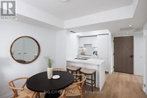 Toronto (Thorncliffe Park) condo for rent - A modern kitchen with a round table and chairs, a sink, and a mirror on the wall.