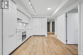 Toronto (Thorncliffe Park) condo for rent - A spacious kitchen with white appliances and wooden flooring.