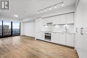 Toronto (Thorncliffe Park) condo for rent - A spacious kitchen with white cabinets and a wooden floor.