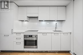 Toronto (Thorncliffe Park) condo for rent - A modern kitchen with white cabinets and stainless steel appliances.