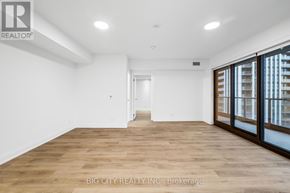 Toronto (Thorncliffe Park) condo for rent - A spacious room with wooden flooring and white walls.