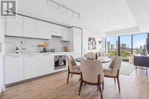 Toronto (Thorncliffe Park) condo for rent - A modern kitchen with white cabinets and a dining table set for four.