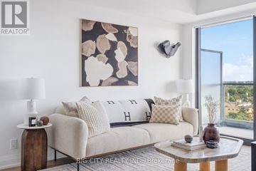 Toronto (Thorncliffe Park) condo for rent - A living room with a couch, a table, and a painting on the wall.