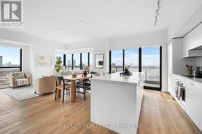 Toronto (Thorncliffe Park) condo for rent - A modern kitchen and dining area with a view of the city.