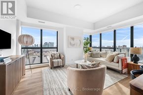Toronto (Thorncliffe Park) condo for rent - A living room with a large window overlooking a cityscape.