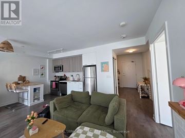 Brampton (Northwest Brampton) condo for rent - A living room with a green couch and a coffee table.