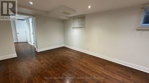 Toronto (Yorkdale-Glen Park) apartment for rent - A room with wooden flooring and white walls.